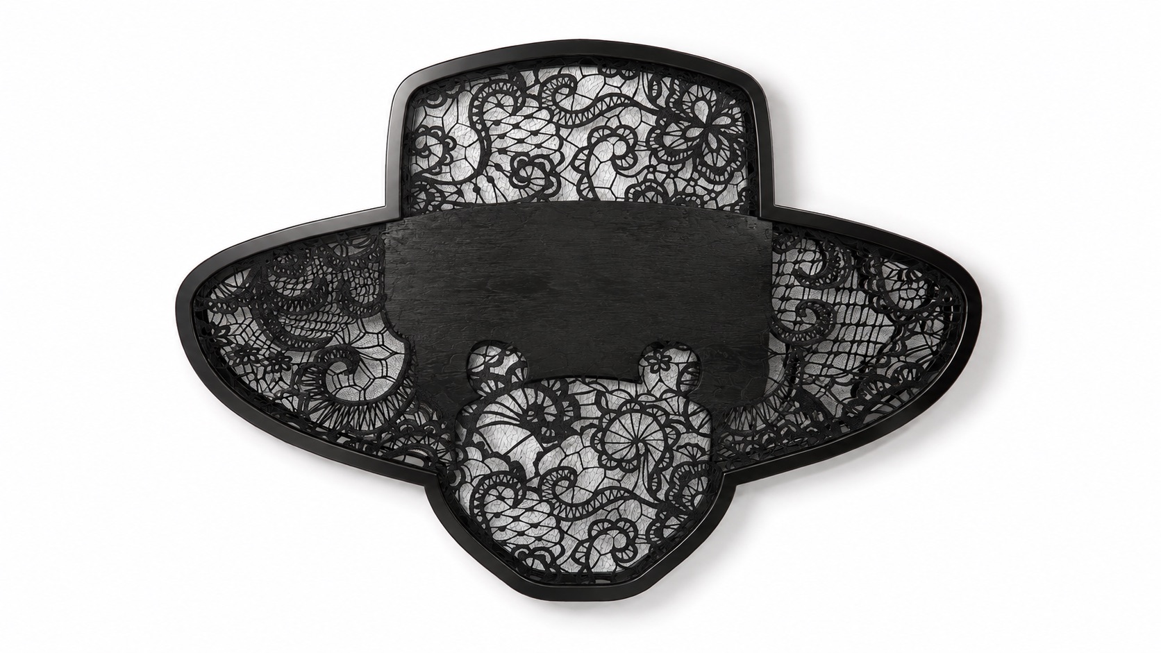 Hero Reliefs black sculptural wall objects with intricate openwork